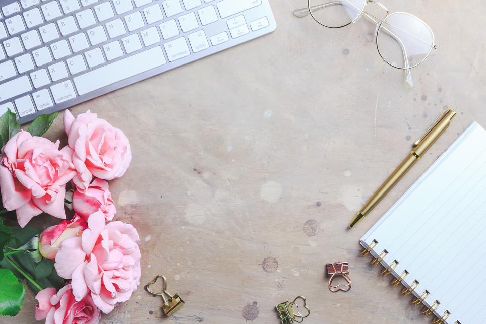 Office desk with computer and rose flowers